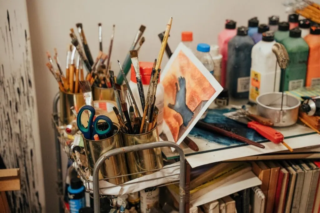 paint and brushes on a trolly