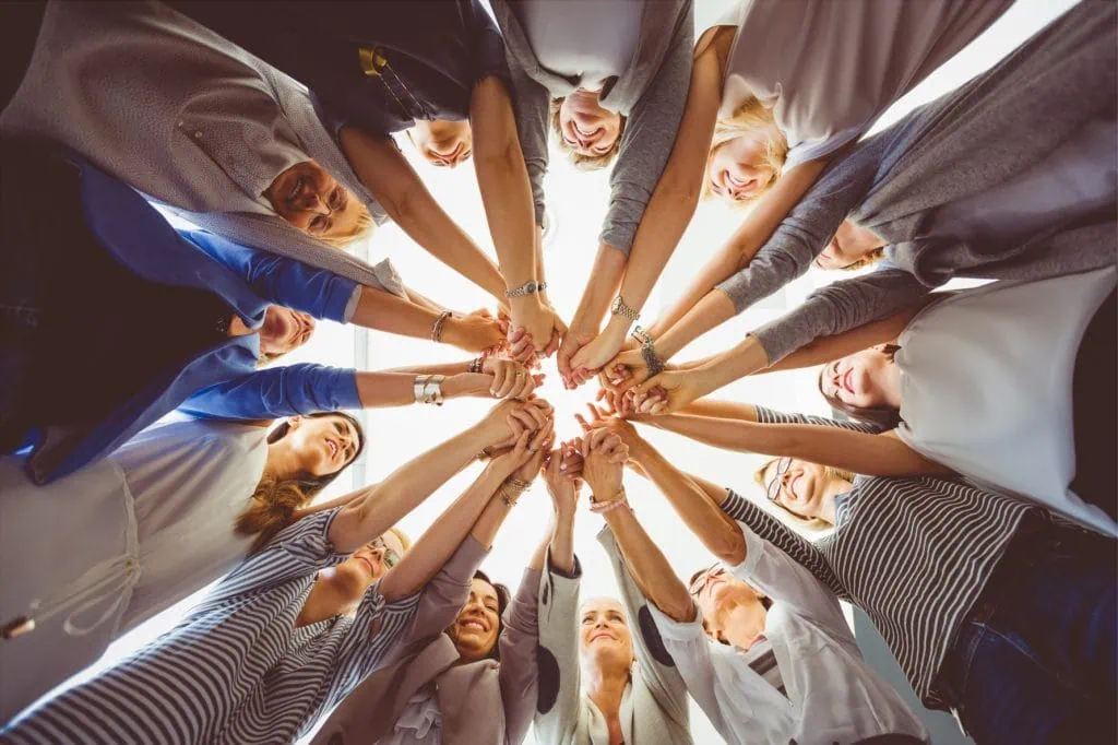 Group of women making a heart with their hands