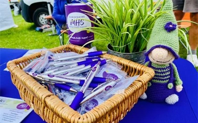 Mini Smudge next to a basket of pens