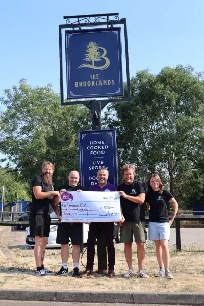 Team at Brooklands receiveing raised money